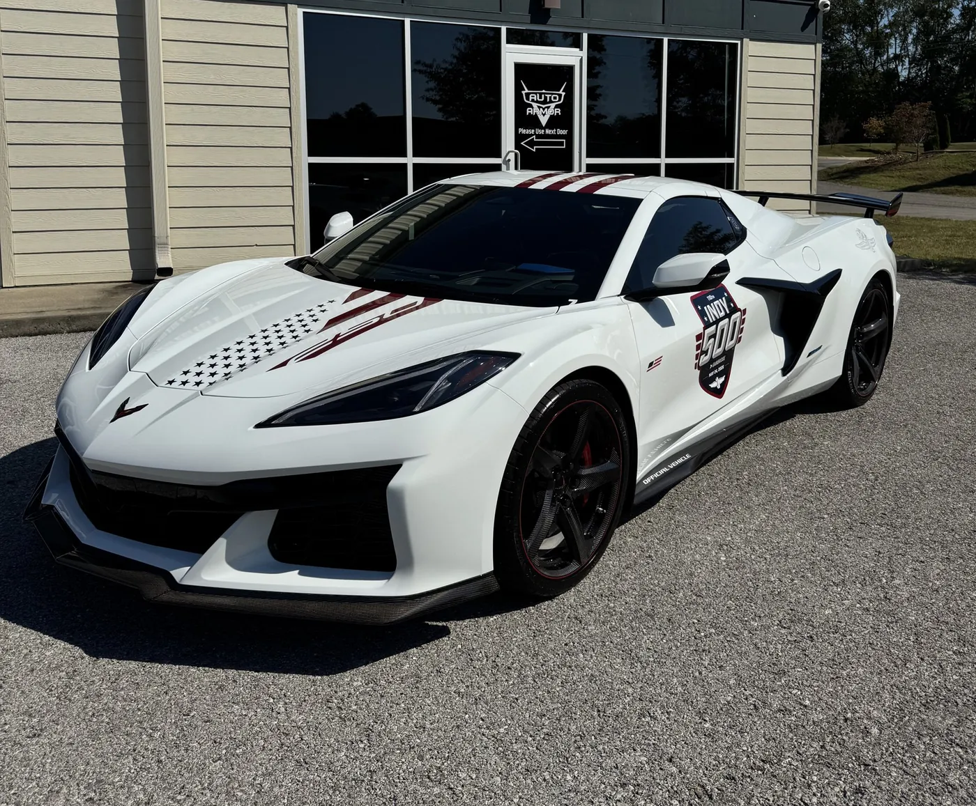A white Corvette parked outside the Auto Armor shop in Bowling Green