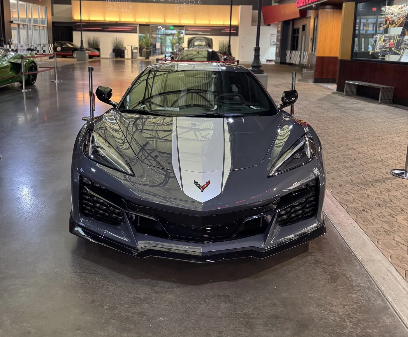 Close view of a gray Corvette hood and headlight with a fresh, glossy finish
